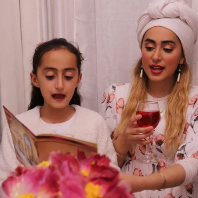 Mother and Daughter singing at Seder table