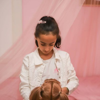 Girl playing with doll