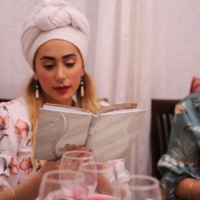 Woman reading Haggadah