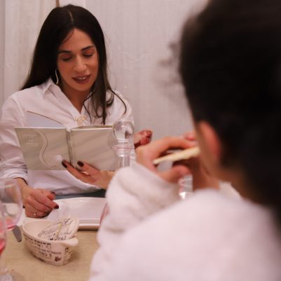 Woman reading Haggadah 3