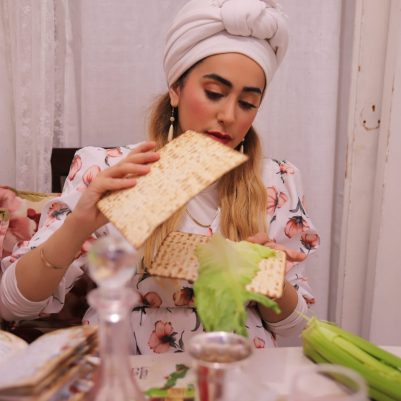 Woman making Korech sandwich at Seder