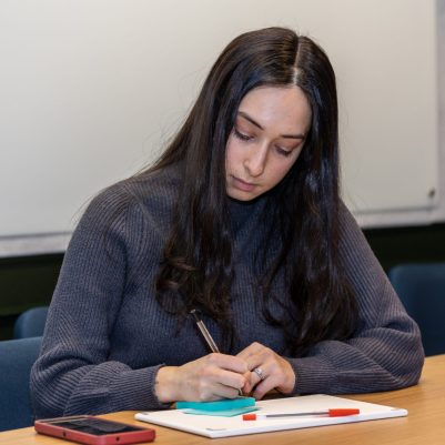 Woman taking notes at a meeting