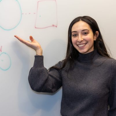 Woman pointing to drawing on whiteboard 2