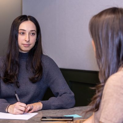 Businesswoman taking notes at meeting 2