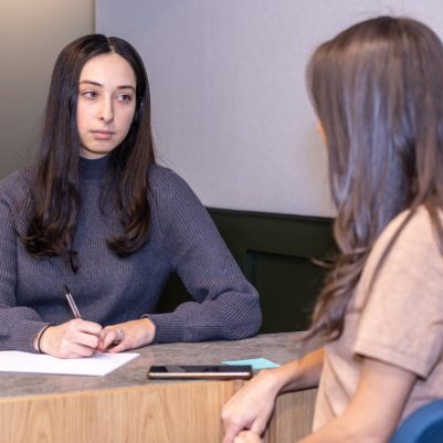 Businesswoman taking notes at meeting 3