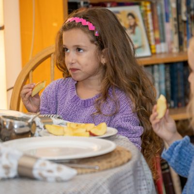 Girls sitting at Rosh Hashana table