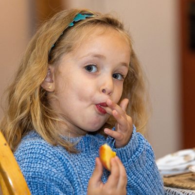 Girl eating apple and honey
