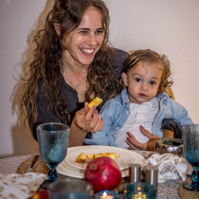Mother and baby dipping apple in honey 1