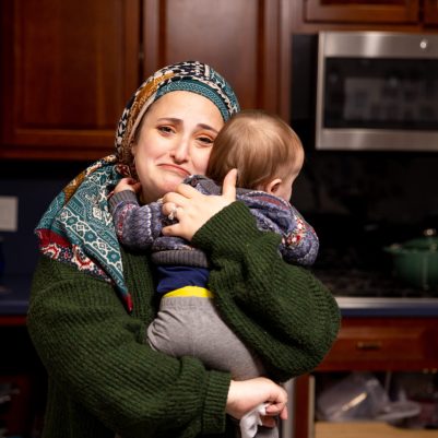 Frowning mother holding baby