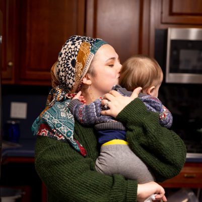 Woman kissing baby on cheek 1