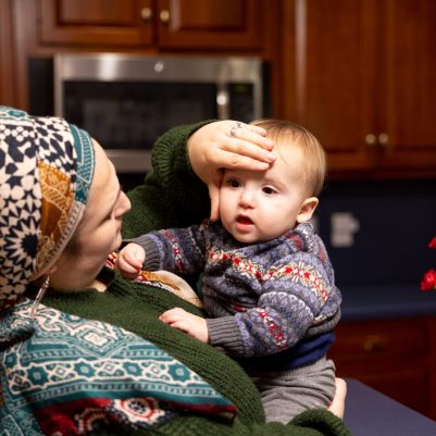 Mother checking baby's temperature