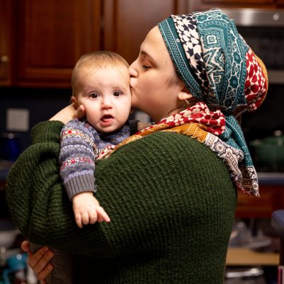 Woman kissing baby on cheek 2