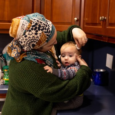 Mother wiping baby's forehead