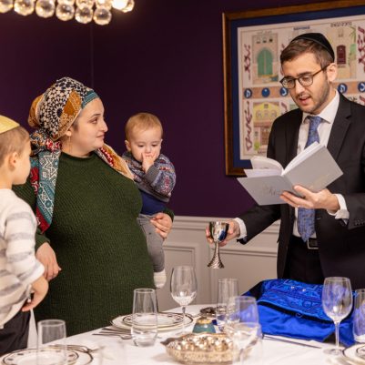 Father making kiddush with family 1