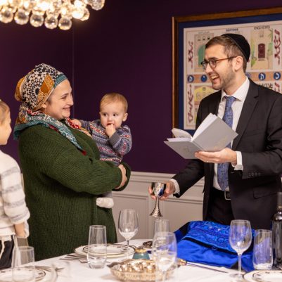 Father making kiddush with family 2