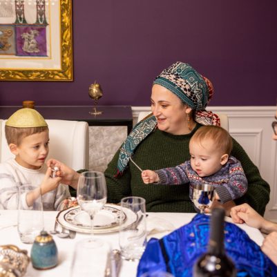 Mother giving kiddush to son 2