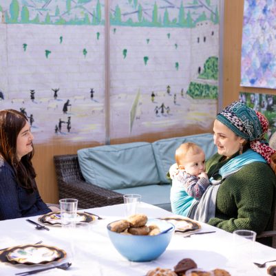 Two women talking in sukkah 2
