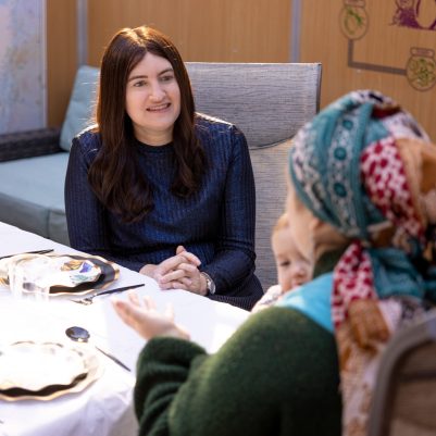 Woman talking to friend in Sukkah 1