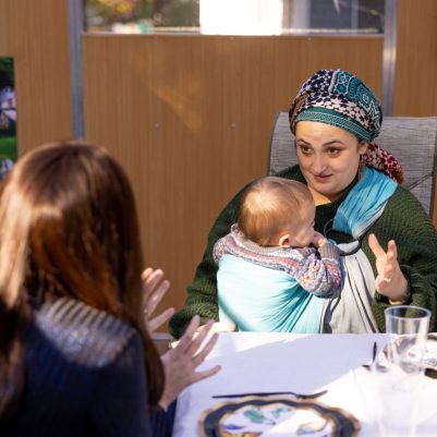 Woman talking to friend in Sukkah 3