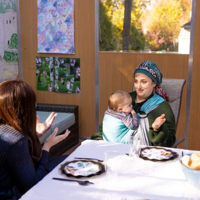 Two women talking in sukkah 3