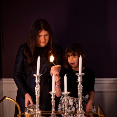 Mother and daughter lighting candles 3