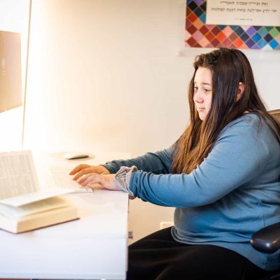 Young woman typing at computer