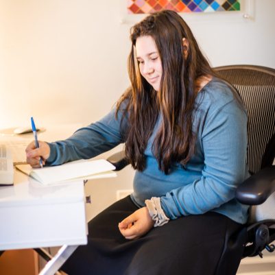 Young woman writing in notebook 1
