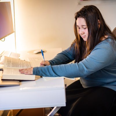 Young woman writing in notebook 2