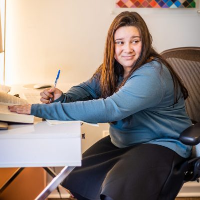 Young woman writing in notebook 3