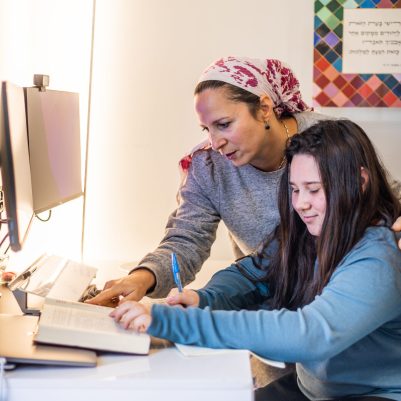 Mother helping teenage daughter with homework 1