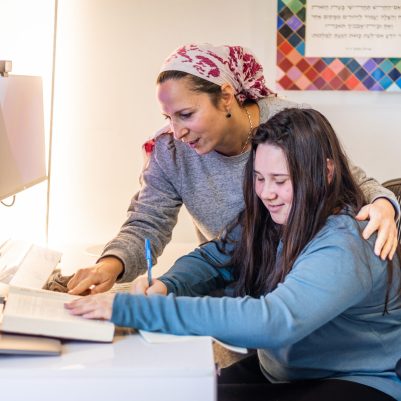 Mother helping teenage daughter with homework 2