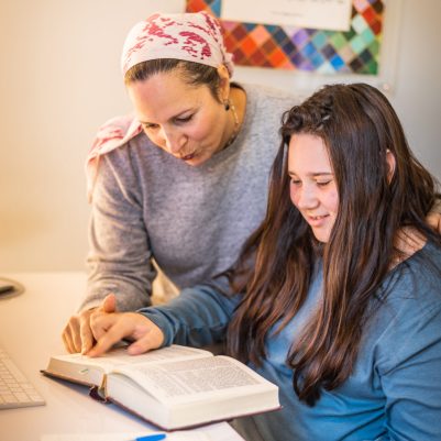 Mother helping teenage daughter with homework 5