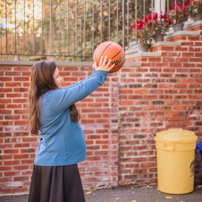 Young woman throwing basketball 1