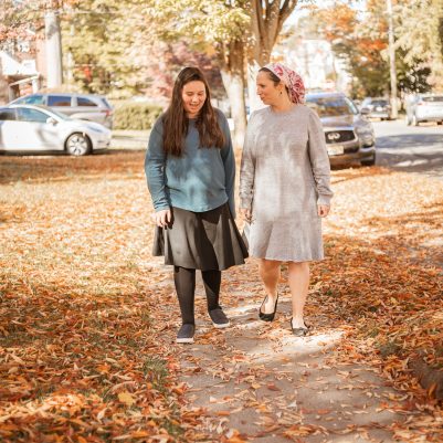 Mother and daughter walking on sidewalk 2