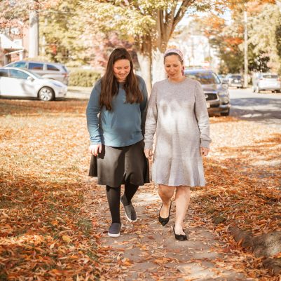 Mother and daughter walking on sidewalk 3