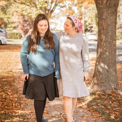 Mother and daughter walking on sidewalk 4