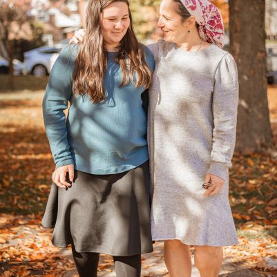 Mother and daughter talking on a walk outside 1