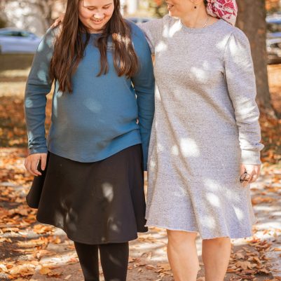 Mother and daughter talking on a walk outside 2