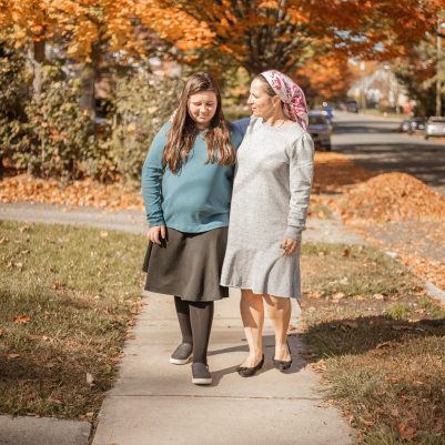 Mother and daughter walking on sidewalk 5