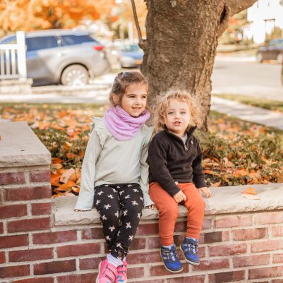 Sister and brother sitting outside 1