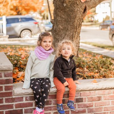 Sister and brother sitting outside 2