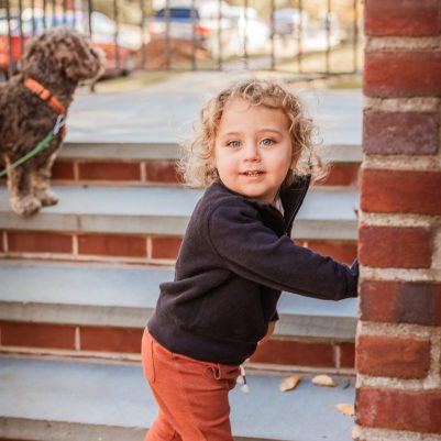 Toddler standing on porch