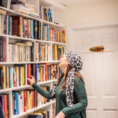 Woman choosing book off shelf