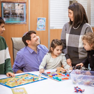 Family playing board game in Sukkah 4