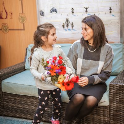 Daughter giving flowers to mother 1
