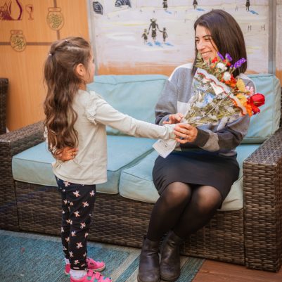 Daughter giving flowers to mother 3