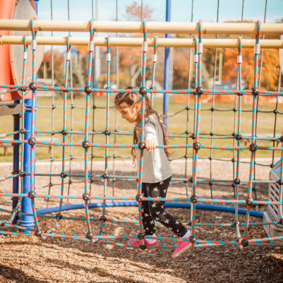 Girl playing on jungle gym 2