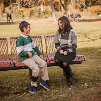 Mother and son talking on bench