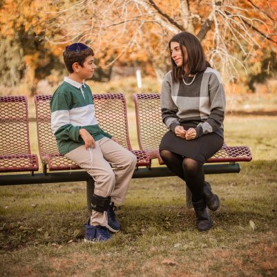Mother and son talking on bench 2