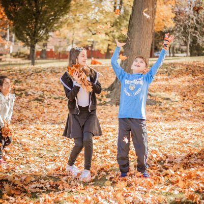 Family throwing leaves in park 1